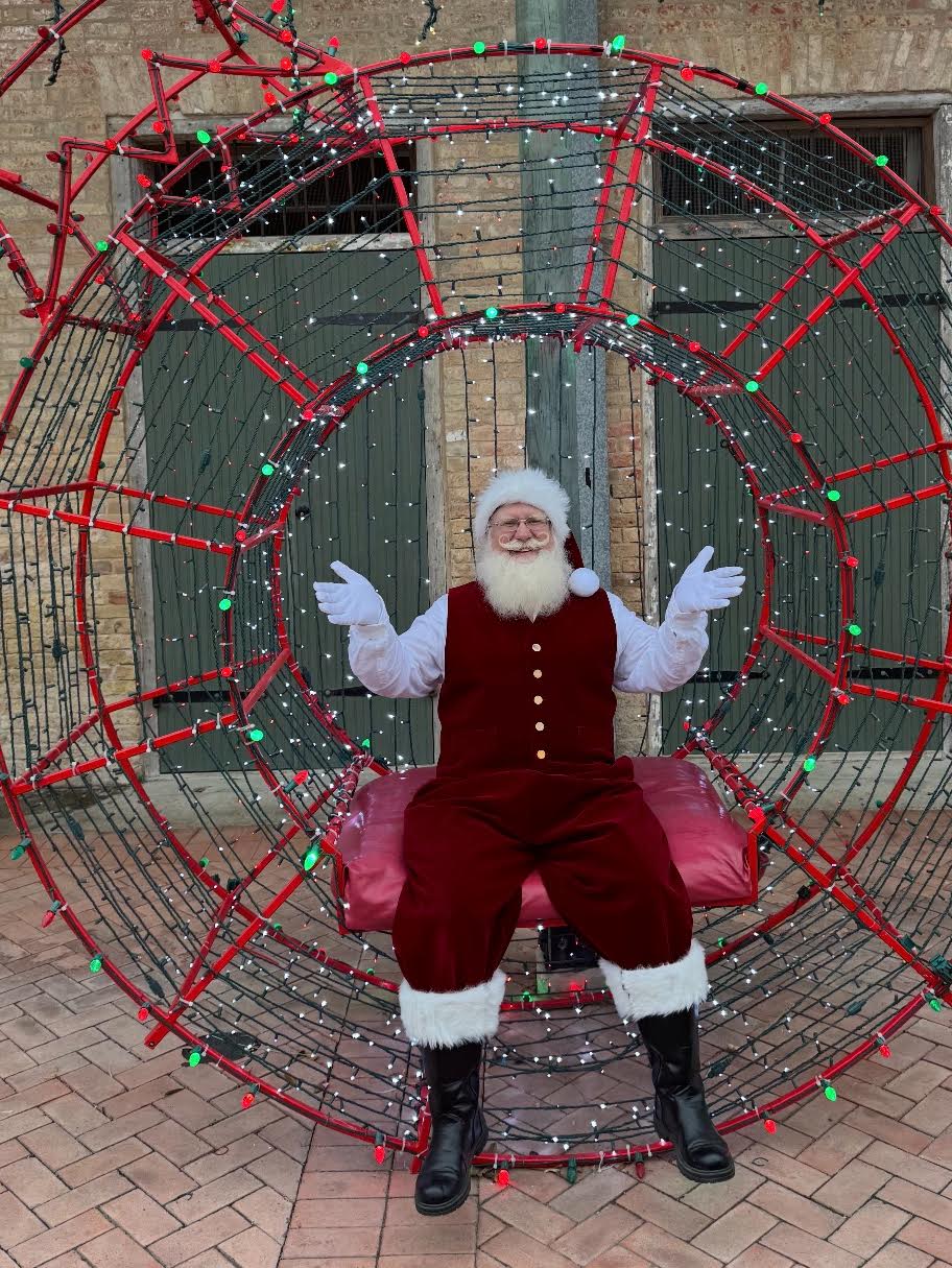 Santa Jangle seated in a Christmas ring of lights