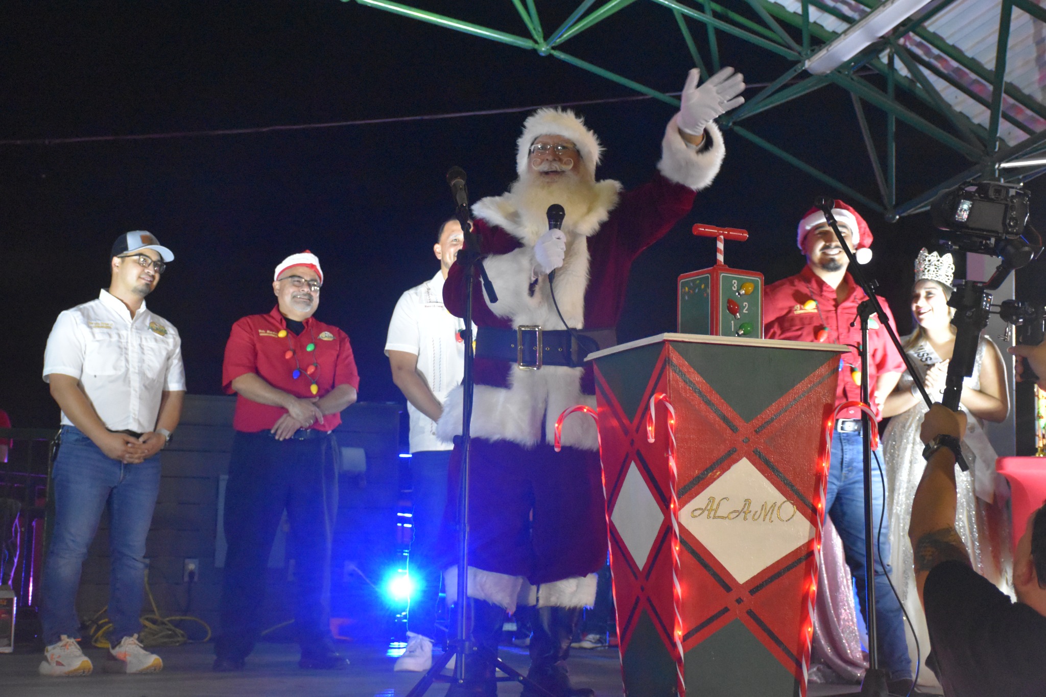 Santa Jangle speaking on stage with a microphone